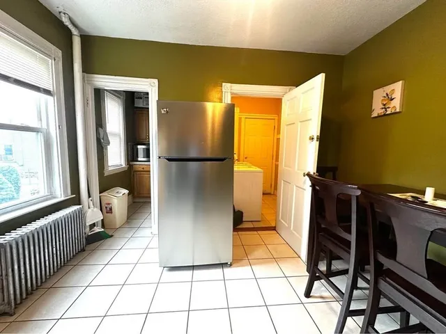a kitchen with a refrigerator and a stove top oven