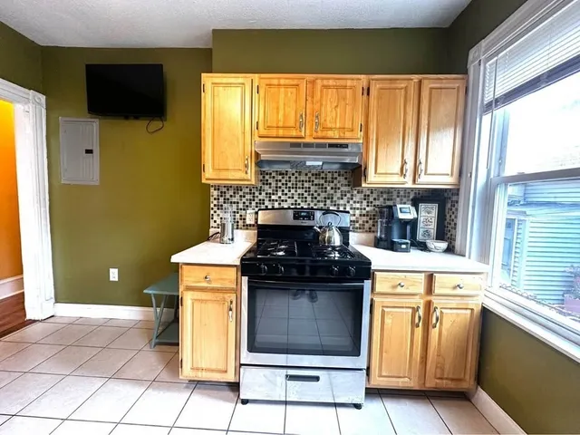 a kitchen with a stove a sink and a refrigerator