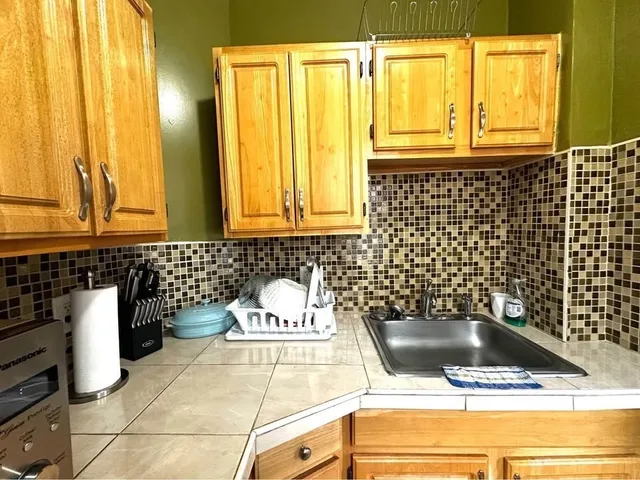 a kitchen with a sink and cabinets