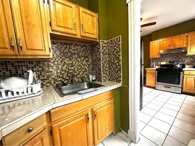 a kitchen with a sink a stove and refrigerator