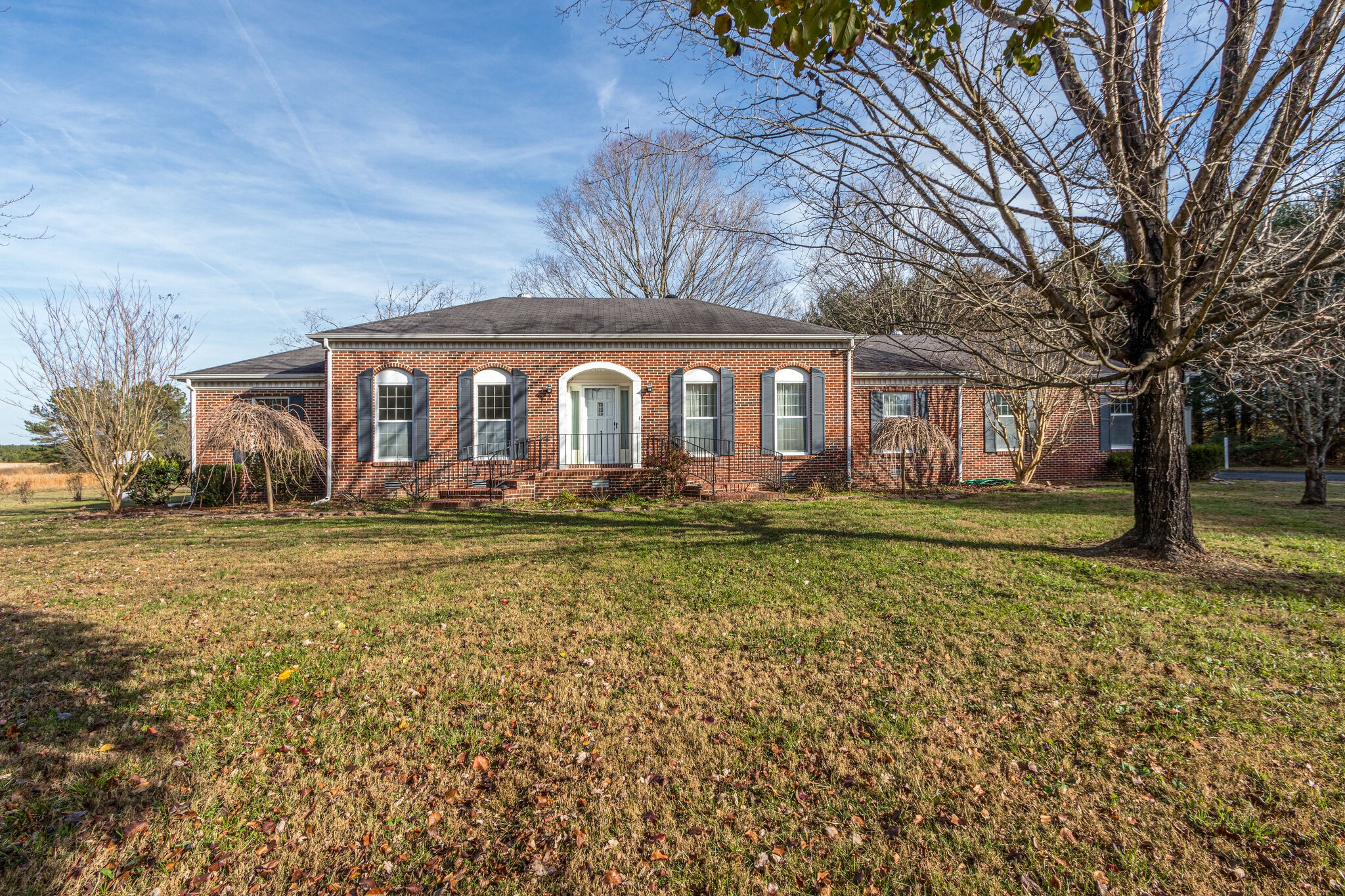 3083 Hickerson Road Manchester, TN 37355 - Photo 1 of 34 a front view of a house with a garden and trees