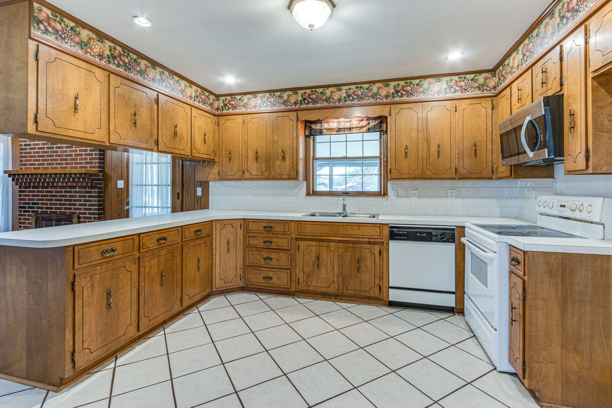 3083 Hickerson Road Manchester, TN 37355 - Photo 12 of 34 a kitchen with stainless steel appliances granite countertop a sink and cabinets