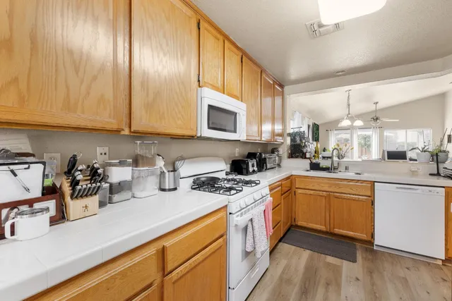 a kitchen with a sink a stove and cabinets
