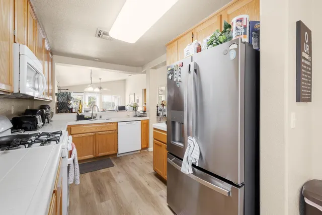 a kitchen with stainless steel appliances a refrigerator sink and microwave