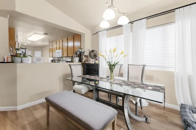a view of a a dining room with furniture window and wooden floor