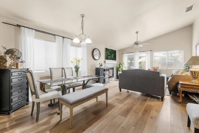 a living room with furniture a window and a chandelier