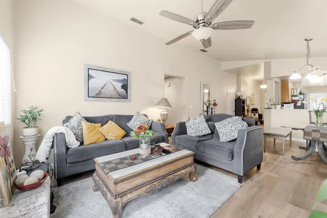 a living room with furniture ceiling fan and a rug