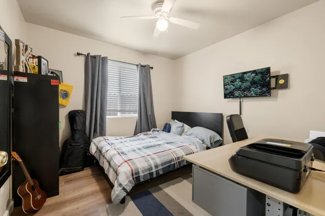 a bedroom with two beds and a flat screen tv