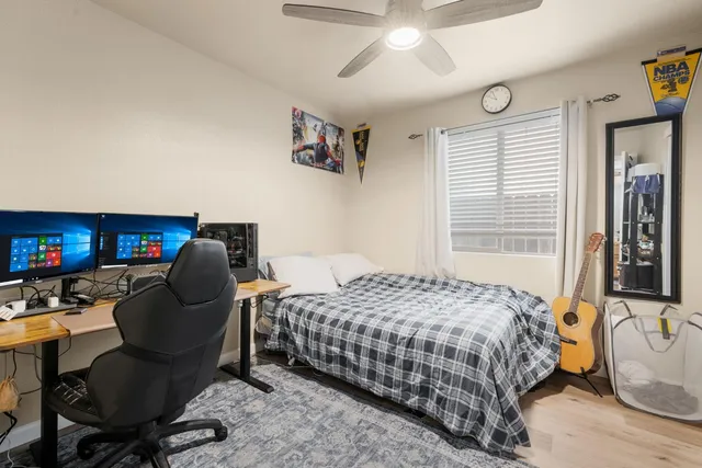 a bedroom with a bed chair and a chandelier