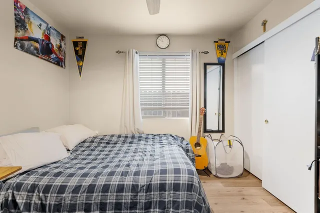 a bedroom with a bed and a window