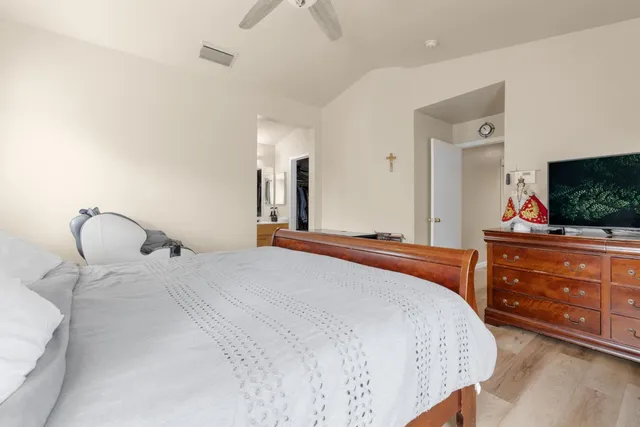 a bedroom with a bed and a flat screen tv