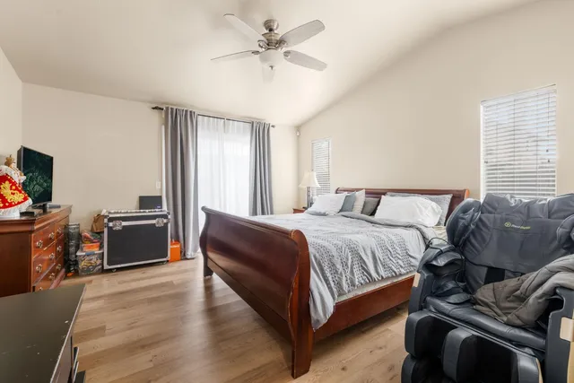 a spacious bedroom with a bed and a chandelier
