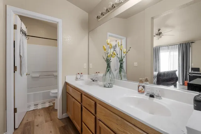 a bathroom with a sink a toilet and shower