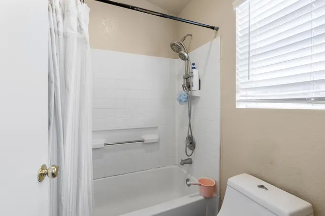 a bathroom with a shower and toilet
