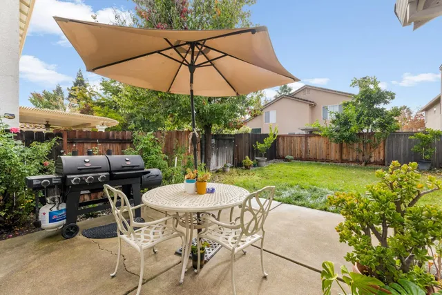 a patio with a patio table and chairs