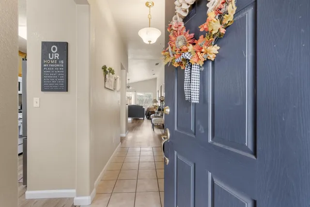 a hallway with painting and a potted plant