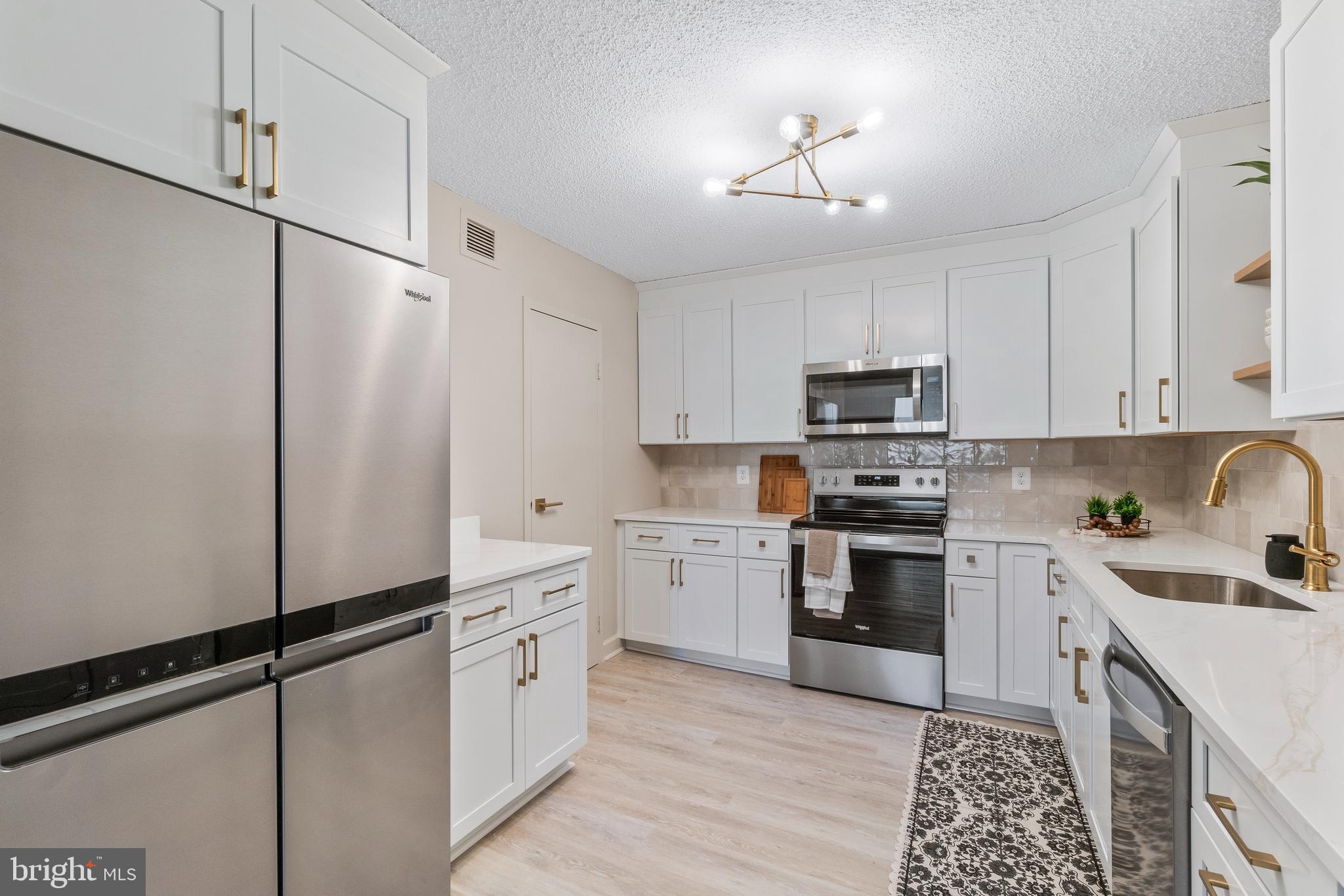 205 East Joppa Road, Unit 2703 Towson, MD 21286 - Photo 20 of 34 a kitchen with white cabinets and white appliances