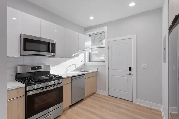 a kitchen with sink stove and microwave