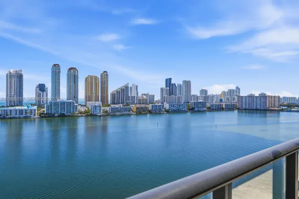 a view of a ocean with boats and palm trees