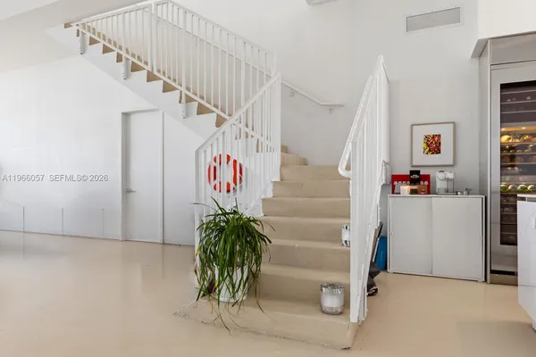 a dining room with furniture a rug and a large window