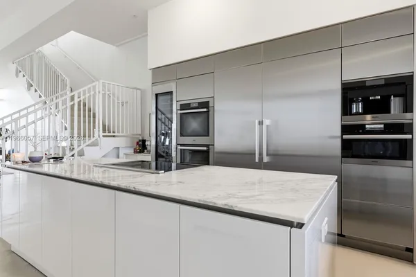 a walk in closet with a lot of stuff and furniture