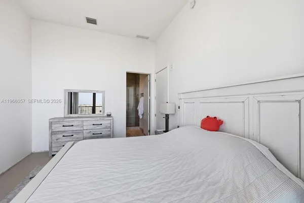 a living room with furniture and large windows