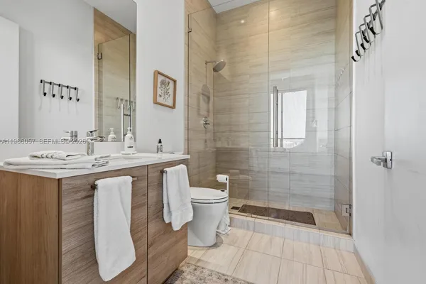 a living room with furniture and floor to ceiling window