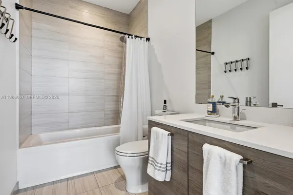 a view of an empty room with windows and balcony