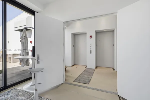 a living room with furniture a large window and a flat screen tv