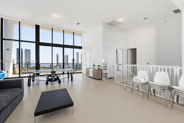 a living room with furniture a rug and a large window