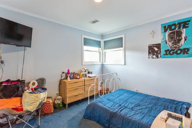 a bedroom with furniture and a window