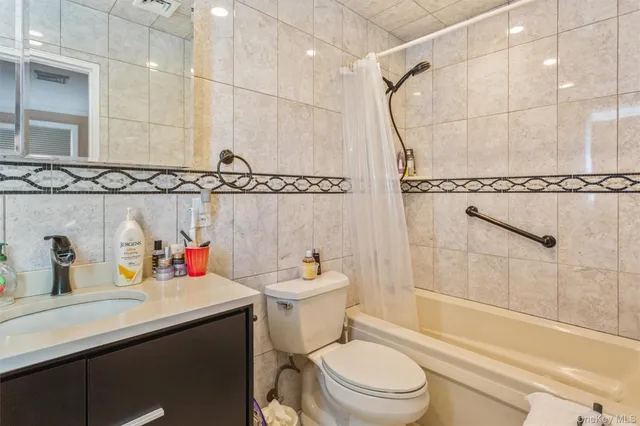 a bathroom with a sink toilet vanity and shower