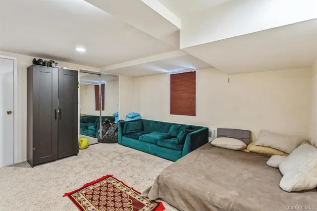 a bedroom with a bed and a couch