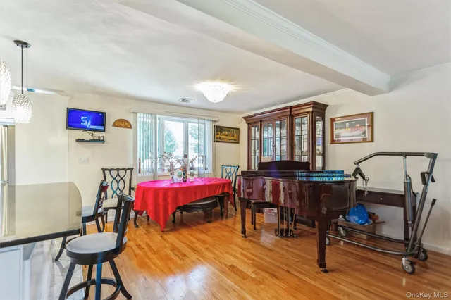 a living room with furniture a window and a flat screen tv