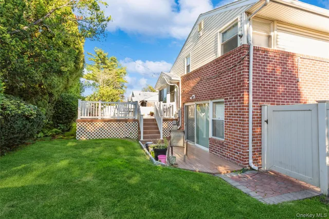 a view of a chair and table in backyard of the house