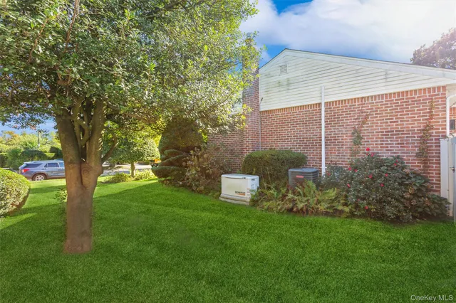 a view of a backyard with table and chairs and a large tree
