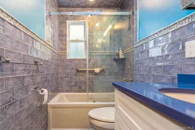 a bathroom with a sink a toilet a bathtub and shower