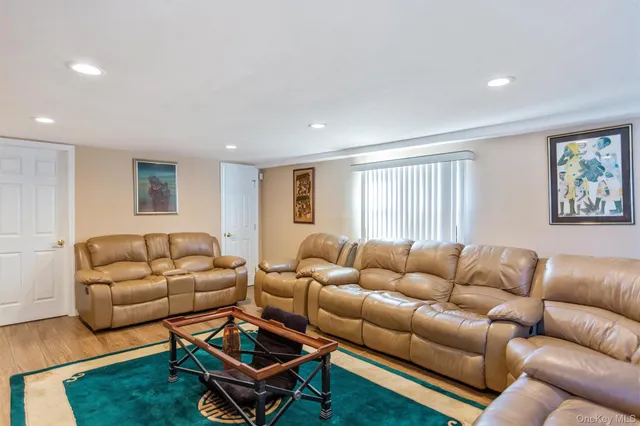 a living room with furniture a rug and a window