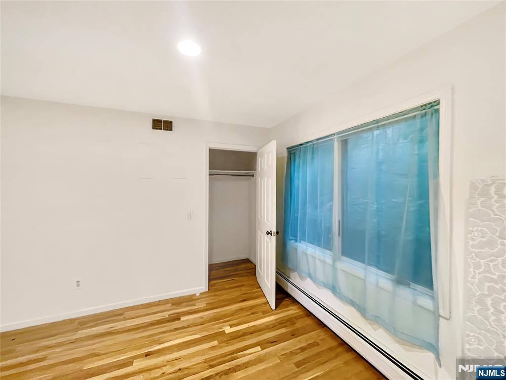 8913 Riverside Place, Unit 3 North Bergen, NJ 07047 - Photo 10 of 17 a view of a room with wooden floor and bathroom
