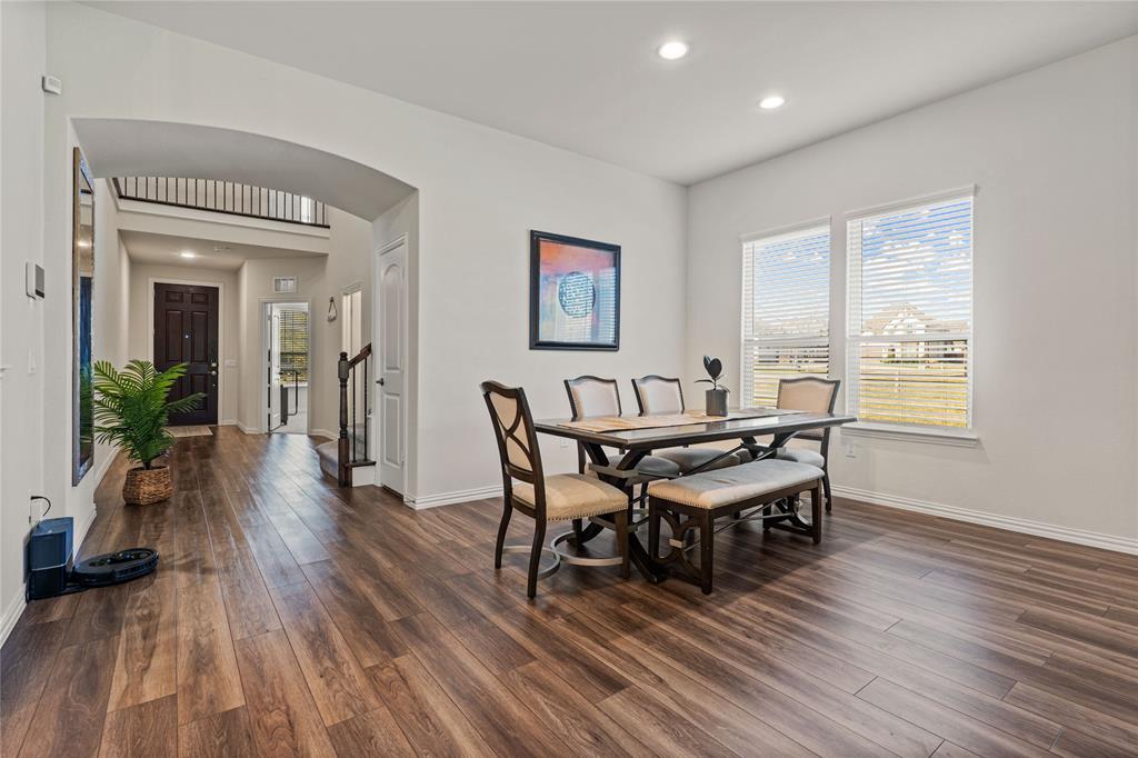 9517 Sunset Lane Oak Point, TX 75068 - Photo 9 of 40 9517 Sunset Lane, Oak Point, TX 75068 - dining area - dining space with arched walkways, recessed lighting, and dark wood-style floors