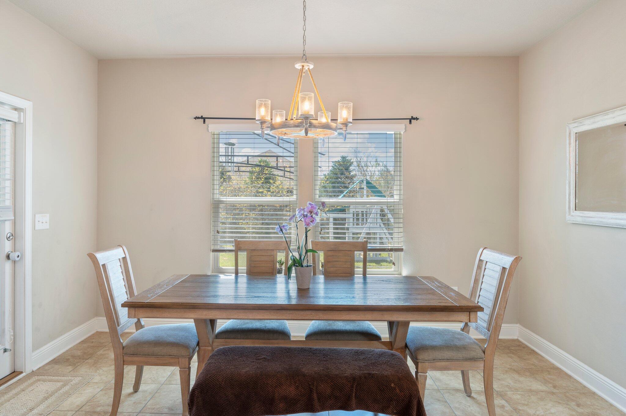 523 Gadwell Street Crestview, FL 32539 - Photo 10 of 30 a view of a dining room with furniture window and wooden floor
