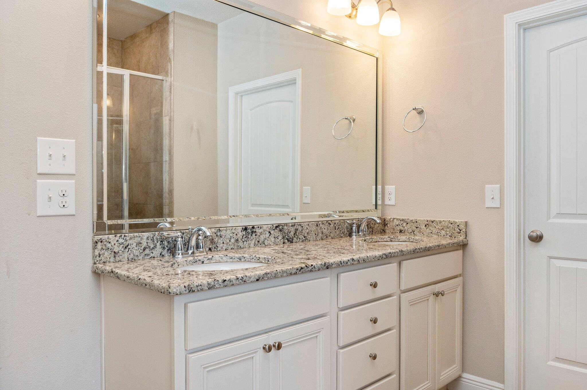 523 Gadwell Street Crestview, FL 32539 - Photo 14 of 30 a bathroom with a granite countertop sink and a mirror