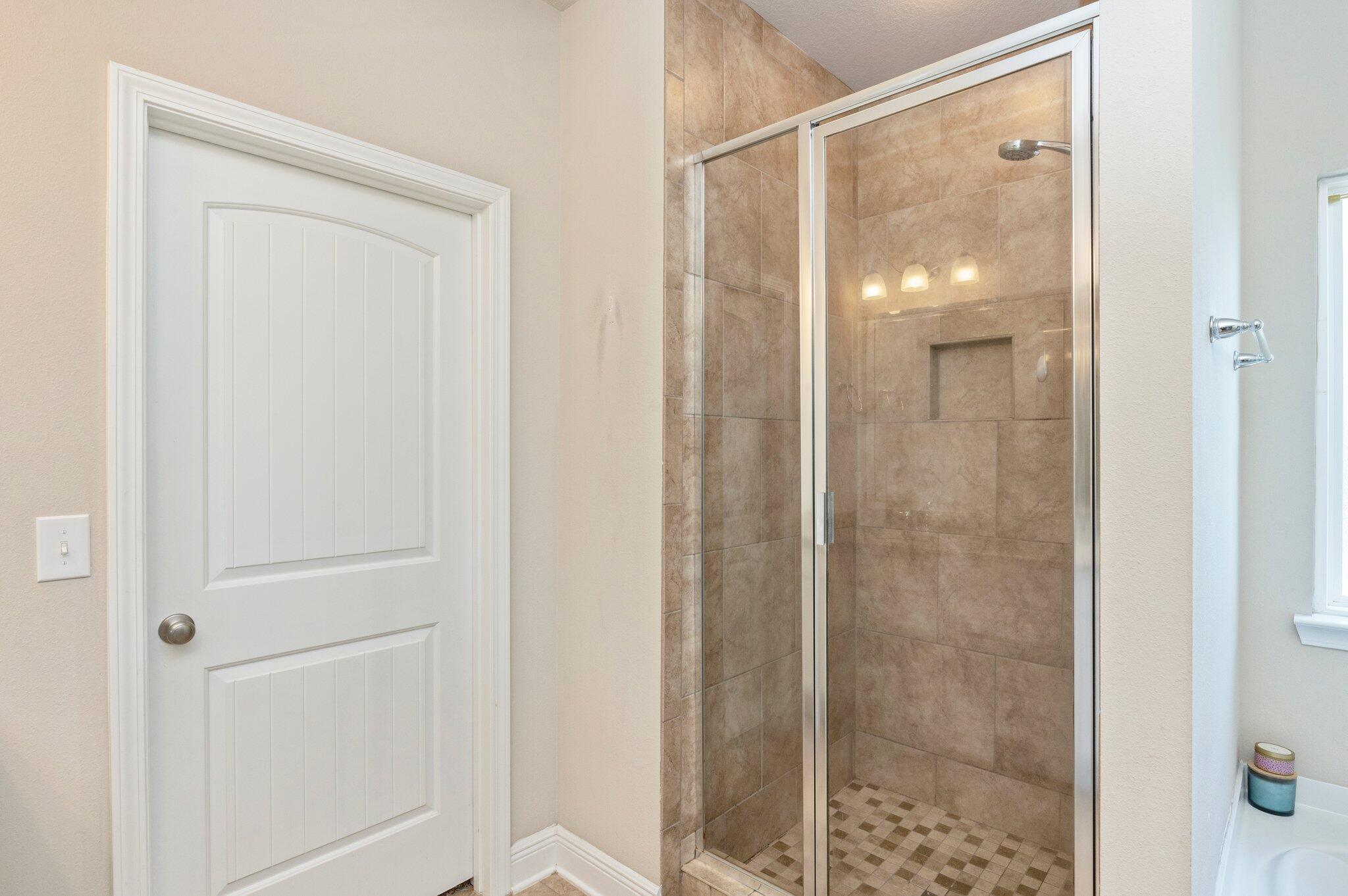 523 Gadwell Street Crestview, FL 32539 - Photo 15 of 30 a bathroom with a glass shower door