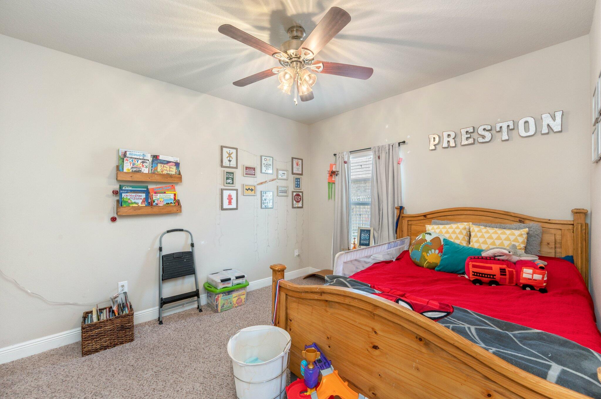 523 Gadwell Street Crestview, FL 32539 - Photo 17 of 30 a bedroom with a bed and a chandelier