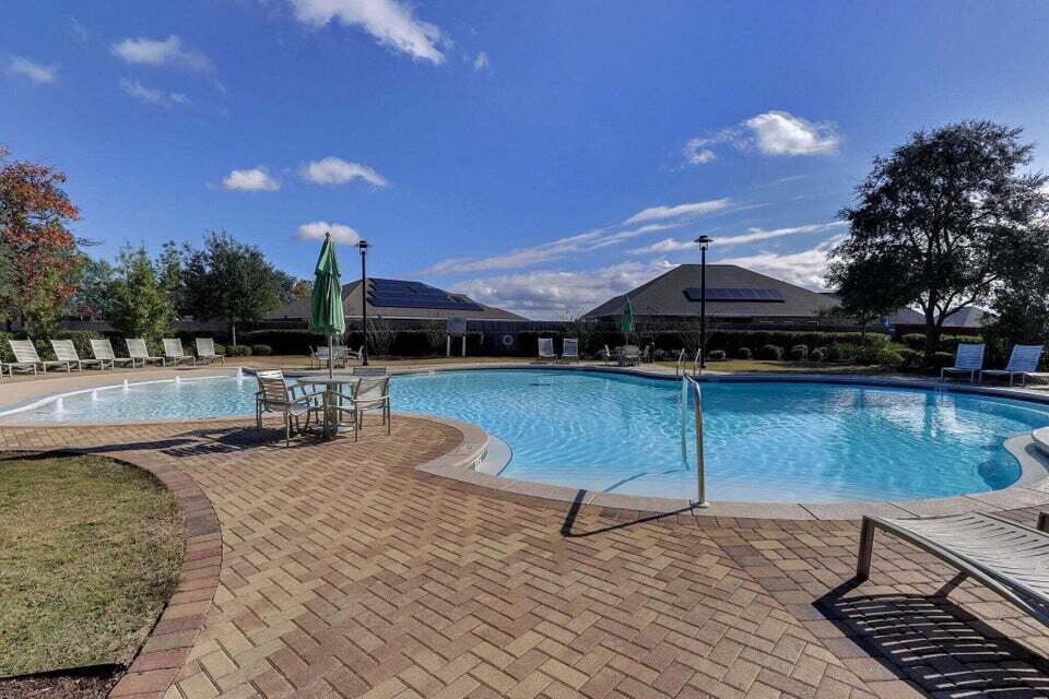 523 Gadwell Street Crestview, FL 32539 - Photo 26 of 30 a view of a swimming pool with a patio and a yard