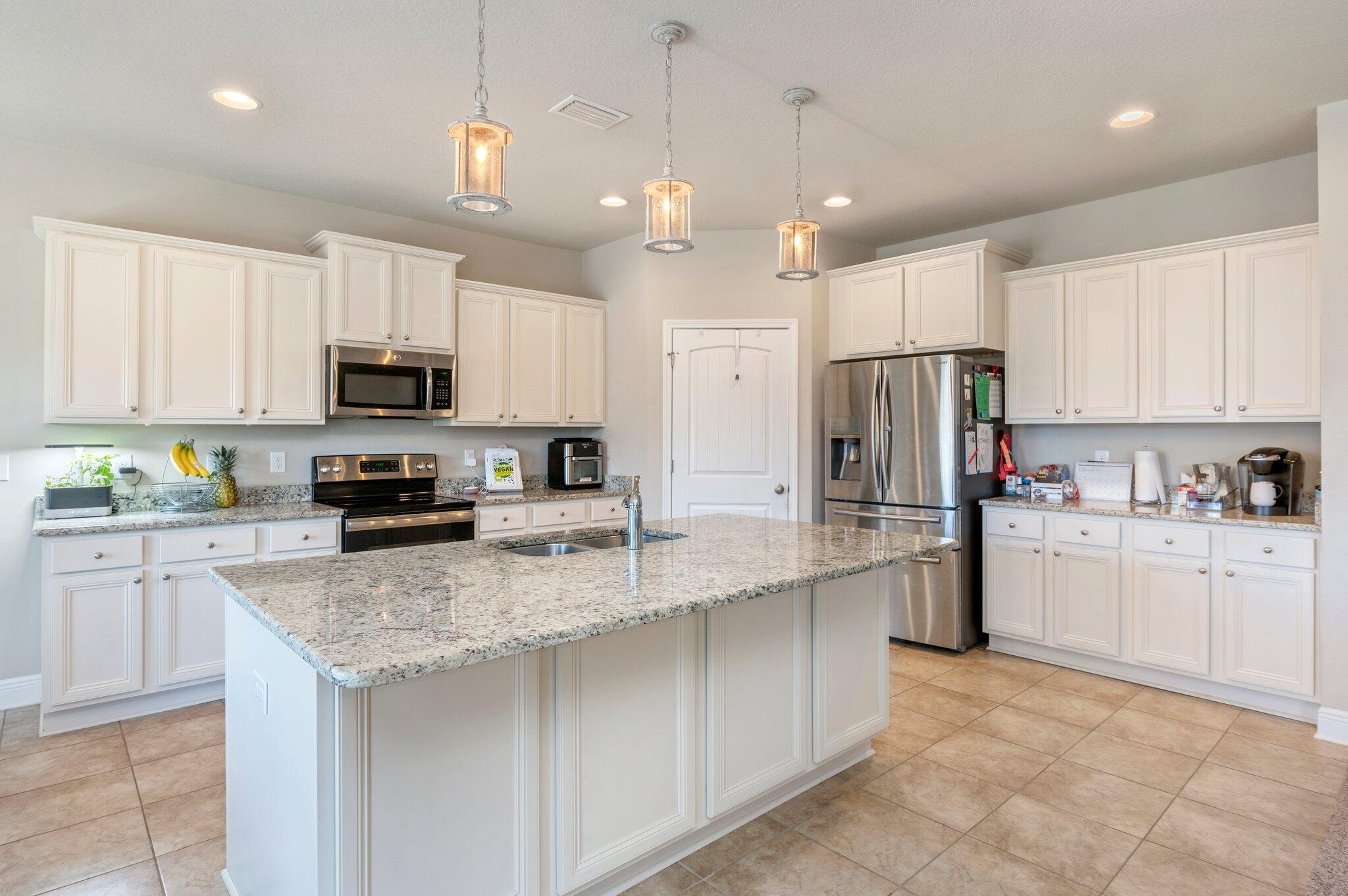 523 Gadwell Street Crestview, FL 32539 - Photo 6 of 30 a kitchen with kitchen island granite countertop stainless steel appliances cabinets a sink and a counter top space