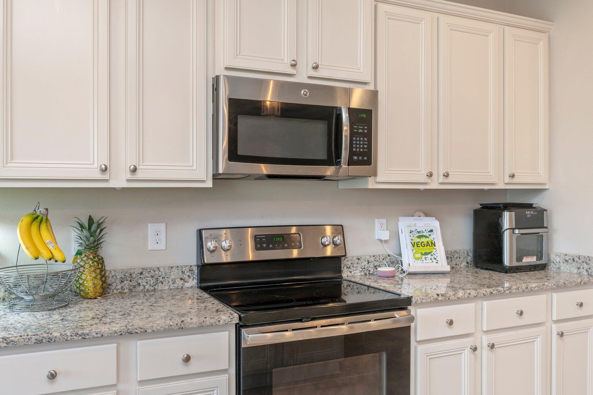 523 Gadwell Street Crestview, FL 32539 - Photo 7 of 30 a kitchen with granite countertop white cabinets stainless steel appliances and a counter space