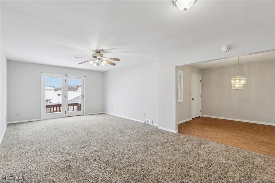 611 Wilson Street Struthers, OH 44471 - Photo 14 of 44 Empty room featuring carpet and a chandelier