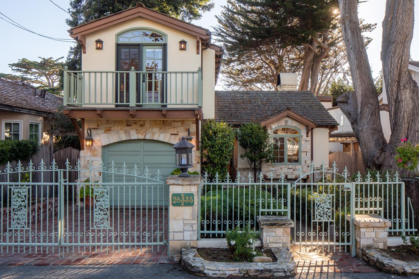 a front view of a house with a iron gate