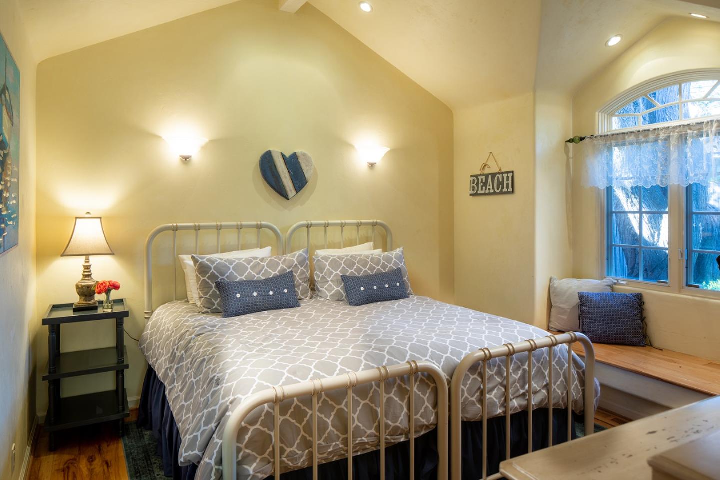 26335 Rio Avenue Carmel, CA 93923 - Photo 11 of 13 a bedroom with a bed and wall painting